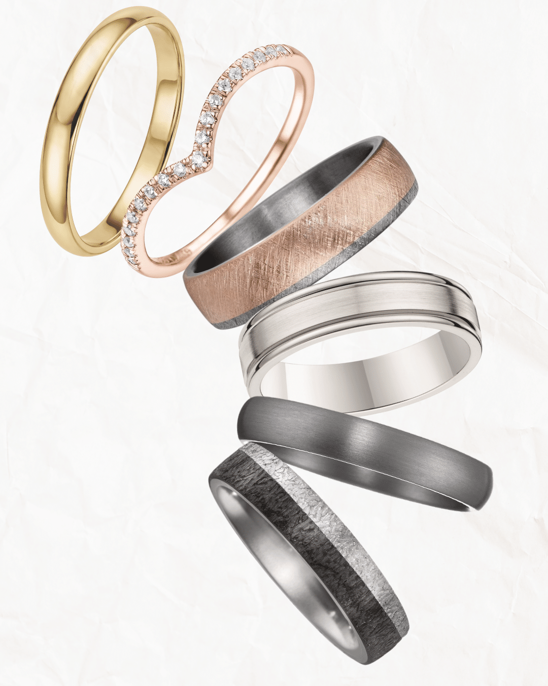 A variety of gold and silver rings creatively displayed in a paper egg carton.